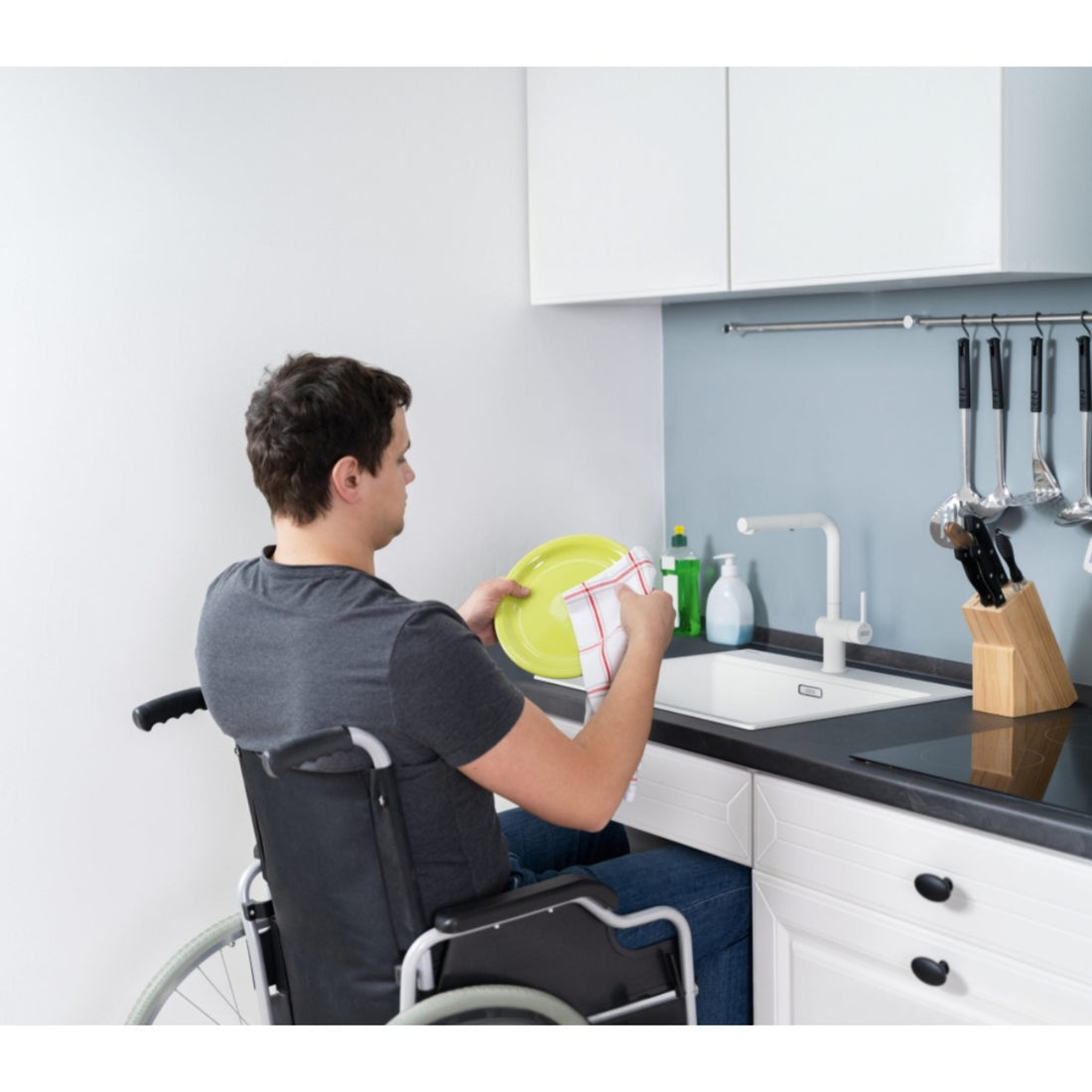 Wheelchair user using a Frabke Maris Bowl Care sink - Best accessible kitchen sinks 2026