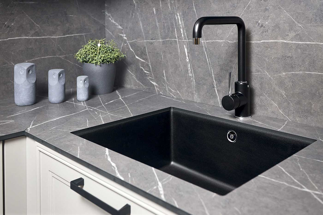 A single handle water tap and composite sink.