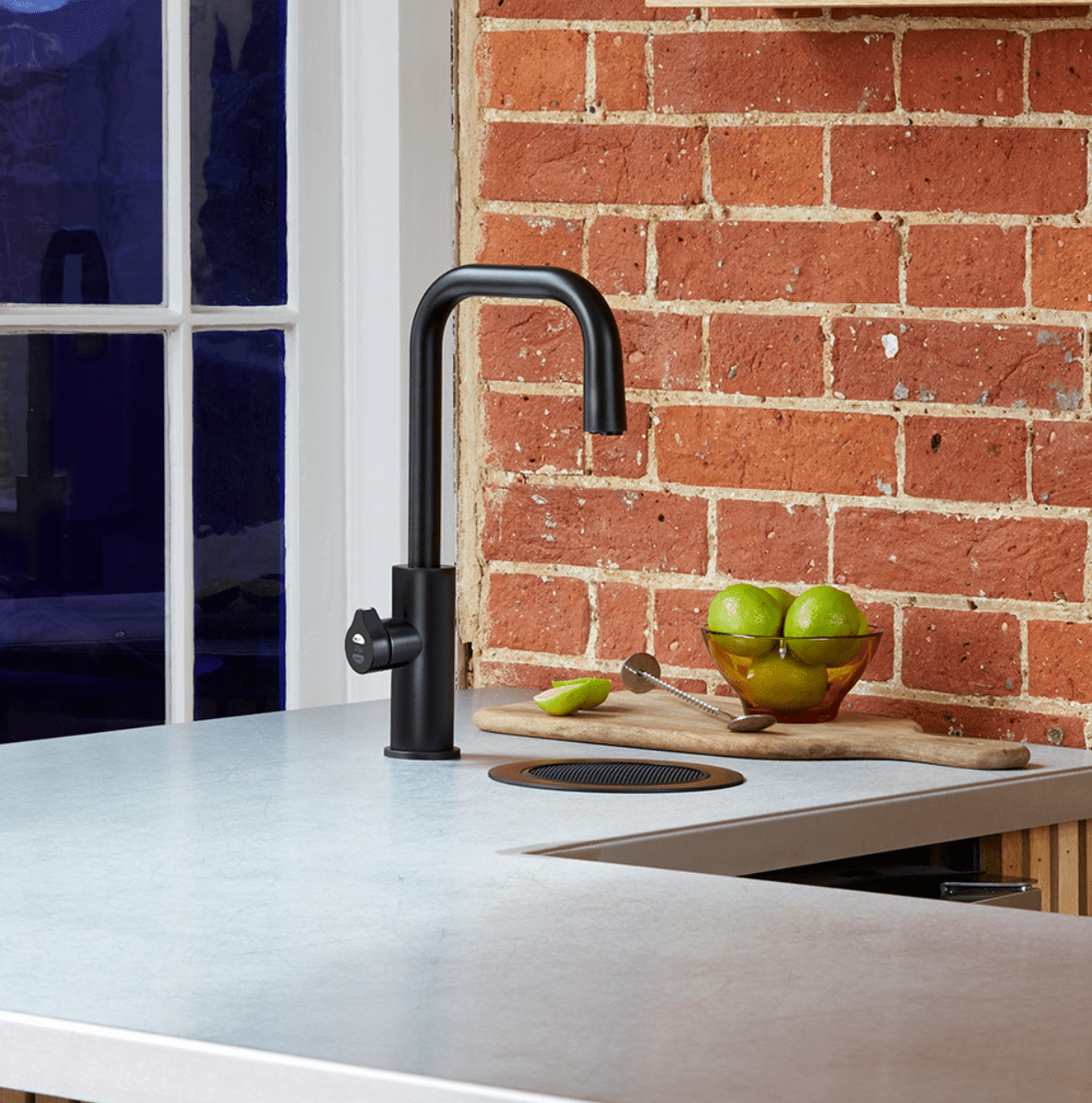 Zip HydroTap Cube Plus Matt Black in modern kitchen with matching font and drain