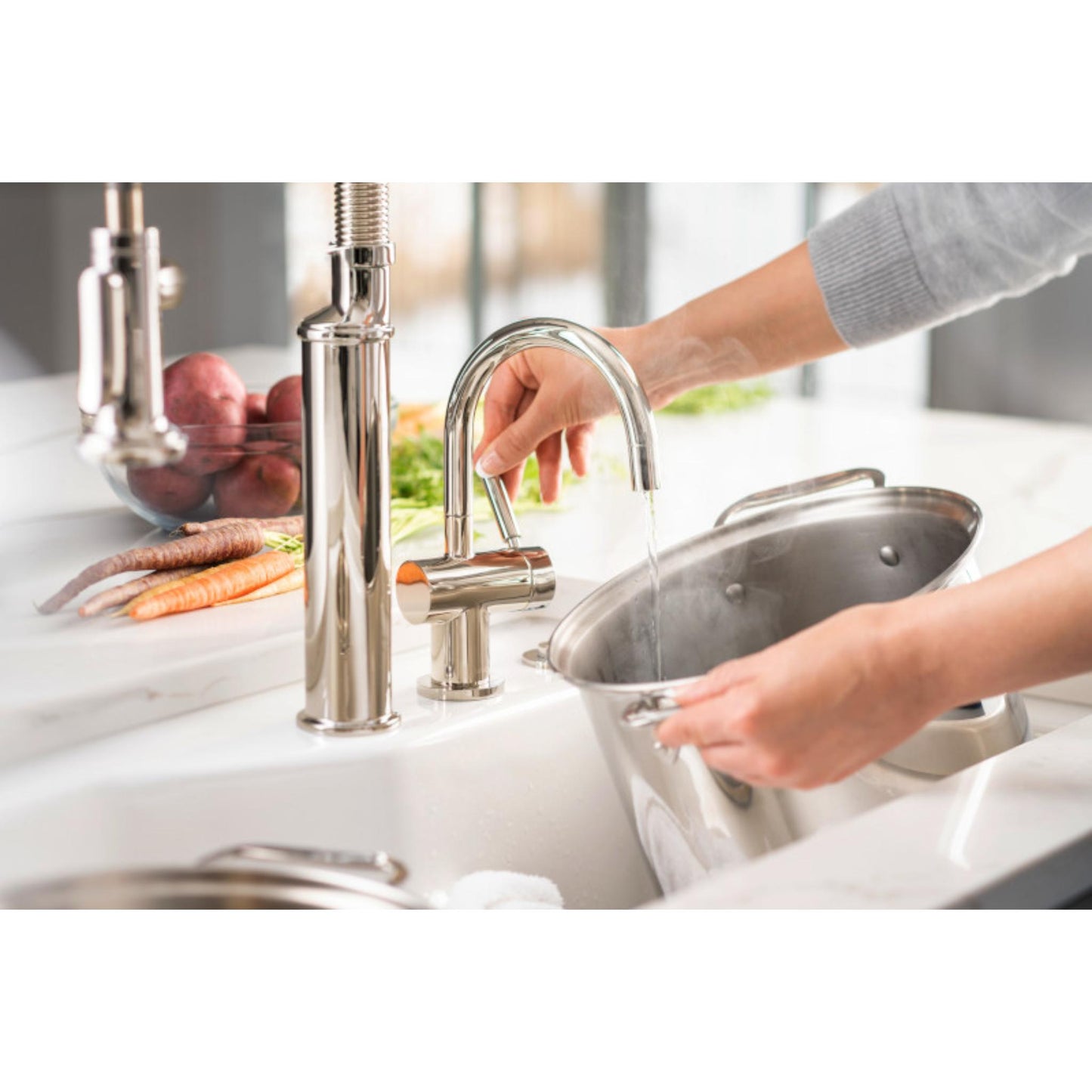 InSinkerErator HC3300 Instant Steaming Hot & Filtered Cold Tap Chrome, dispensing instant hot water, lifestyle  image in all white kitchen