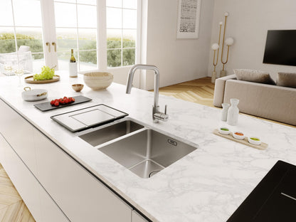 Franke 1.5 bowl stainless steel sink installed in a marble countertop kitchen island.