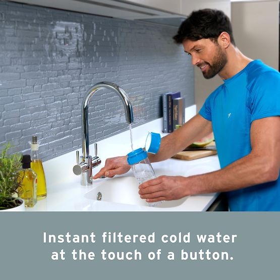 Man uses InSinkErator 4N1 filter water tap to fill a bottle with water.