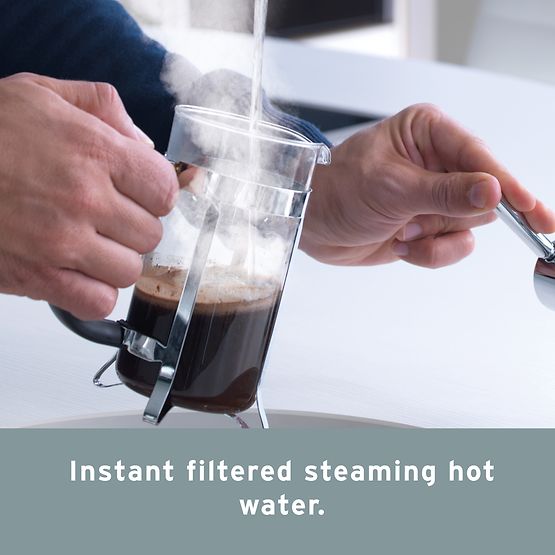 Person uses InSinkErator hot water tap to make coffee.