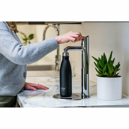 Zip HydroTap Classic Plus G5 with Integrated Font (Bright Chrome) lifestyle image of business man dispensing drinking water into reusable bottle in kitchen